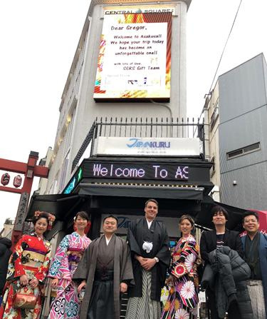 Gregor Zebic during a visit to Japan posing with hosts in traditional dress